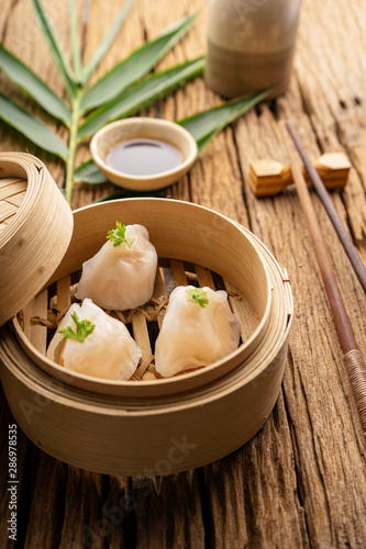 Dim sum, Dim Sum on the wooden table, top view and space for text input , Dim Sum (Chinese food) in steamed bamboo