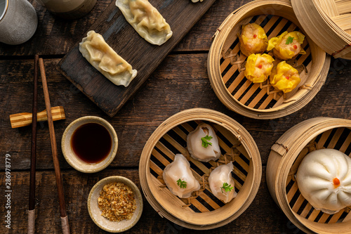 Dim sum, Dim Sum on the wooden table, top view and space for text input , Dim Sum (Chinese food) in steamed bamboo