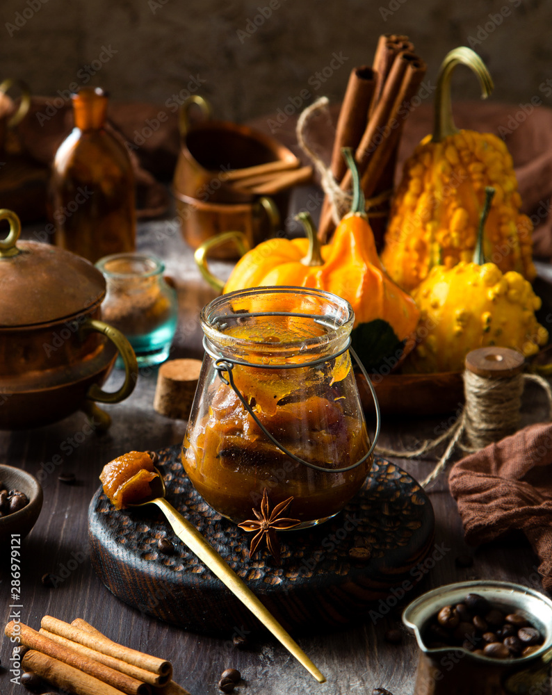 homemade pumpkin spice mix in glass jar on rustic wooden table
