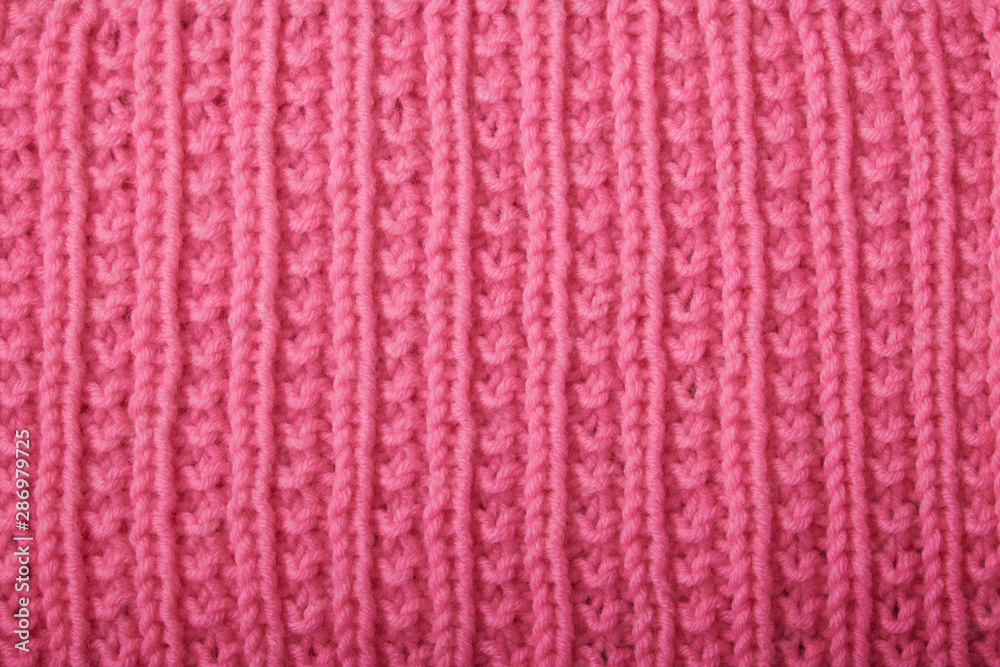knitting sweaters, or a scarf with a red pattern, thin knitting needles on a white wooden background. Close-up. Copy space. knitting sweaters, or a scarf with a red pattern, thin knitting needles on a white wooden background. Close-up. Copy space.