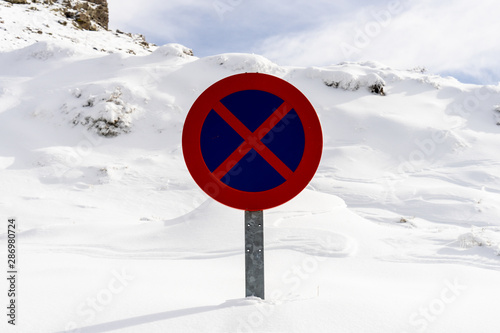 Snowed road sign no parking in Sierra Nevada