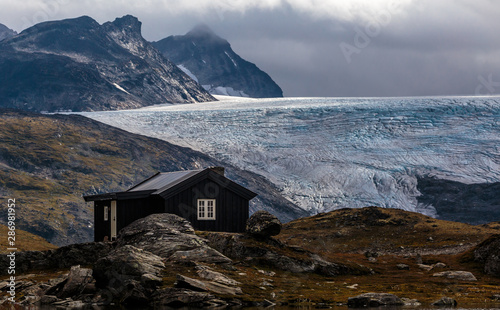 Mountain hut in front of Smørstabbreen glacier in Jotunheimen national park, Norway photo