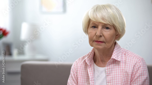 Depressed senior woman looking at camera, social insecurity, low incomes