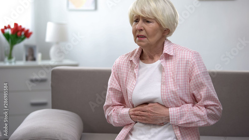 Fotografía Senior woman suffering from epigastria pain, health problems in old age
