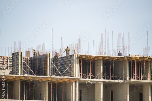 Builders working on the construction of a large building © nellino7
