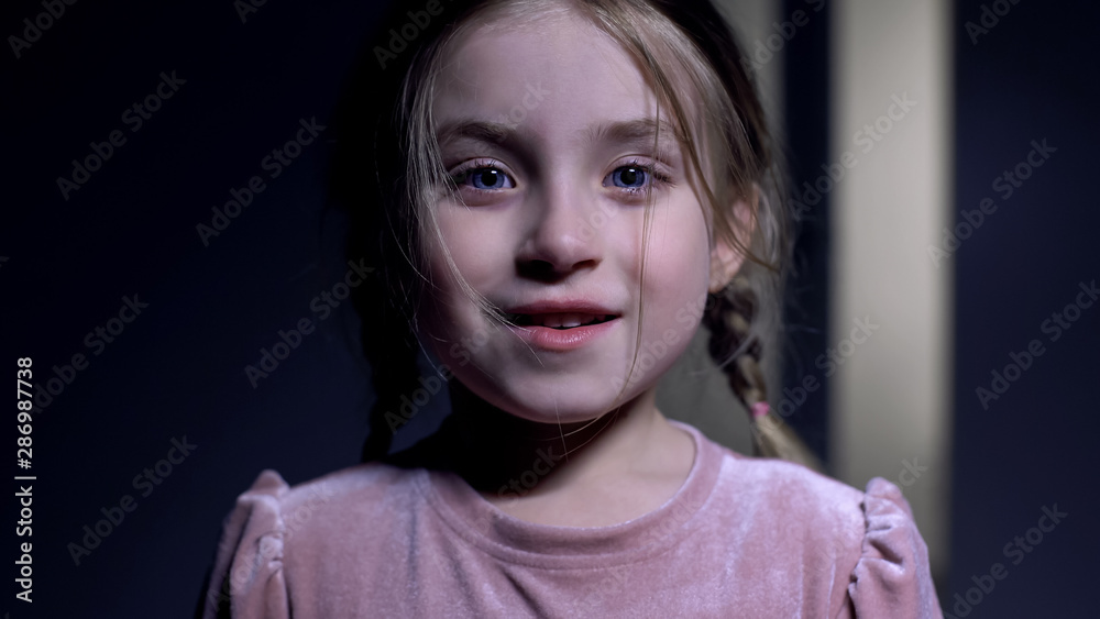 Happy little girl smiling on camera, excited with good news, sincere emotions Happy little girl smiling on camera, excited with good news, sincere emotions