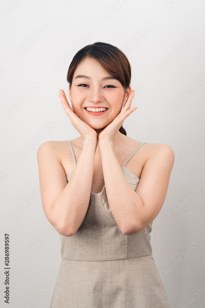 Beautiful young woman touching her face. Fresh healthy skin isolated on white Beautiful young woman touching her face. Fresh healthy skin isolated on white