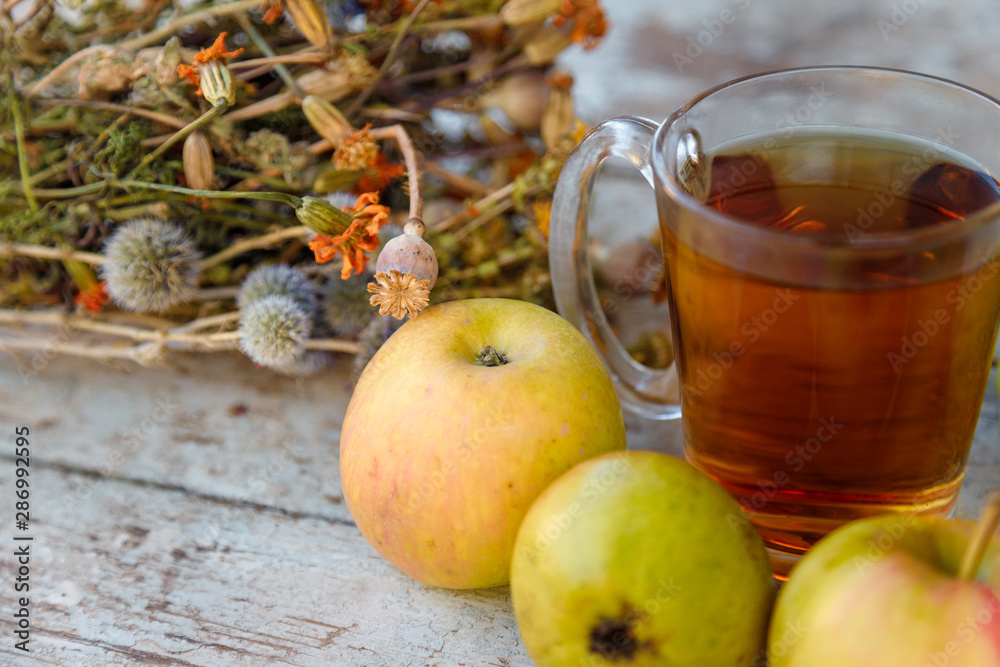 autumn harvest composition with apples pears cup of tea and dry healing herbs on wooden blue table background autumn harvest composition with apples pears cup of tea and dry healing herbs on wooden blue table background