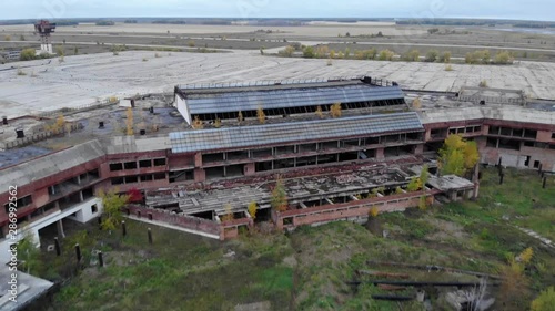 Abandoned airport buildings in middle of dirty fiield photo
