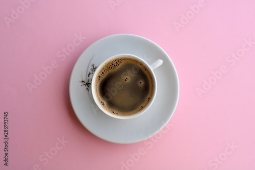 cup of coffee on light pink background