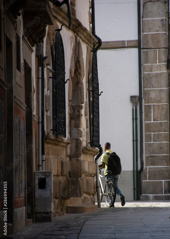 Man With Bicycle Leaving  Alley 