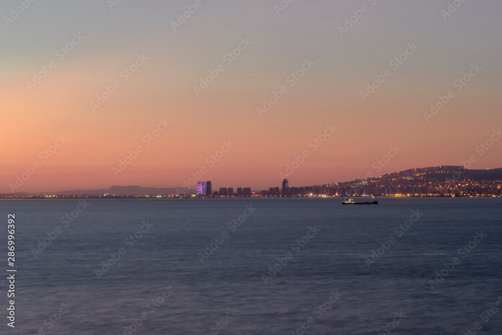 Sunset view over the bay in Izmir,ship and mountains