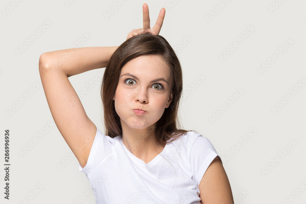 Funny millennial girl have fun grimacing in studio Funny millennial girl have fun grimacing in studio