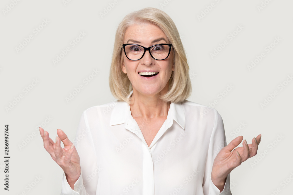 Senior woman in glasses stunned with great sale offer Senior woman in glasses stunned with great sale offer