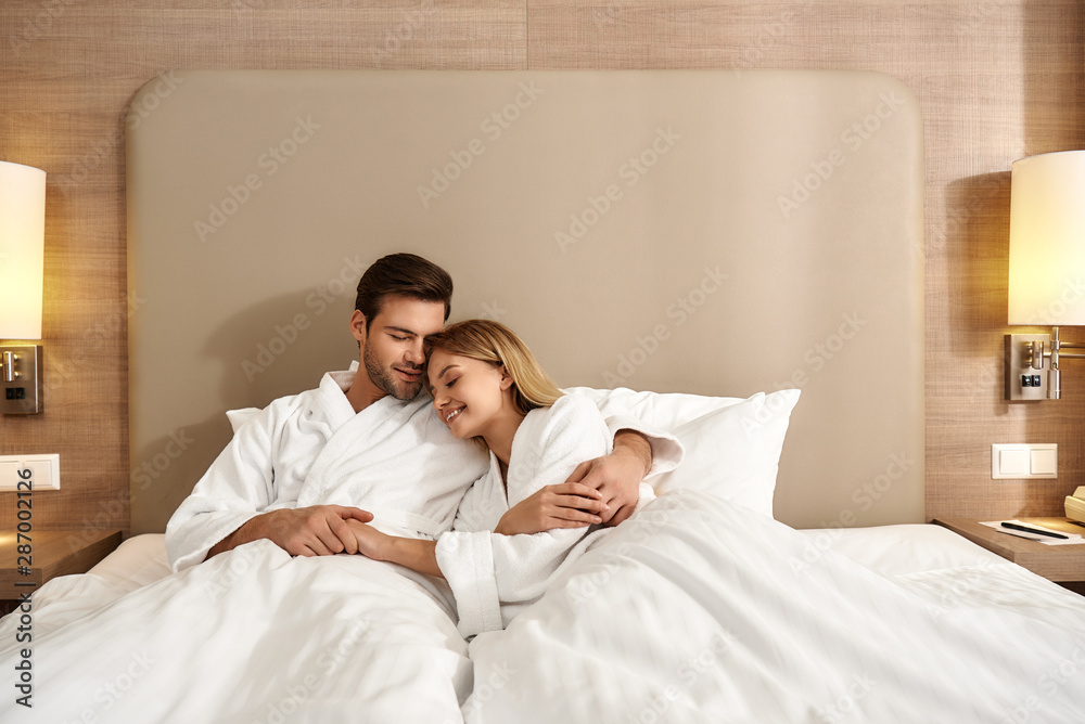 We are better together. Couple relaxing in hotel room wearing robes We are better together. Couple relaxing in hotel room wearing robes