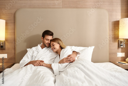 We are better together. Couple relaxing in hotel room wearing robes