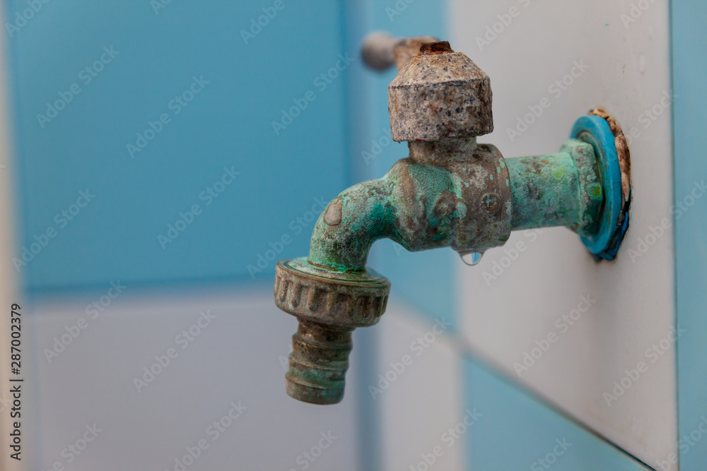 Old rusty water tap in Bathroom. Faucet water. Rust stains on the water