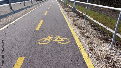 bicycle path with white sign in the park