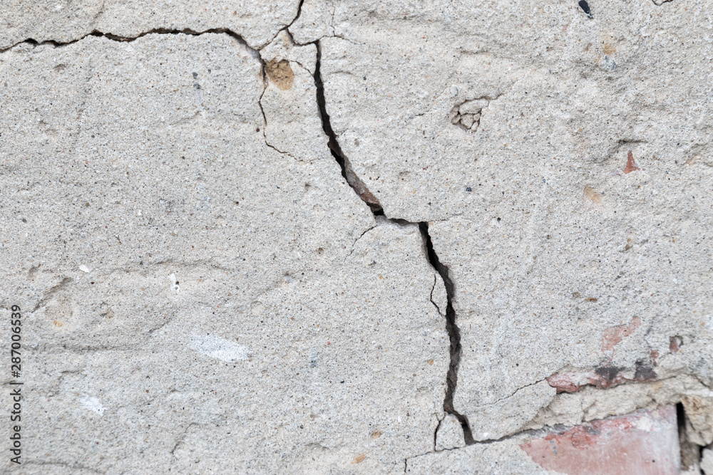 Fototapeta premium Massive crack in the wall concrete in extreme closeup. Concept blueprint for destruction, lose or broken soemetheing.