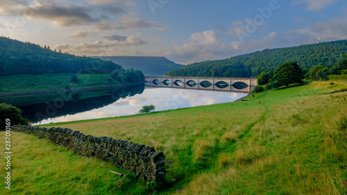 Tableau sur toile Early morning light on the Lady Bower Reservoir and Snake Road Bridge, Peak Dist
