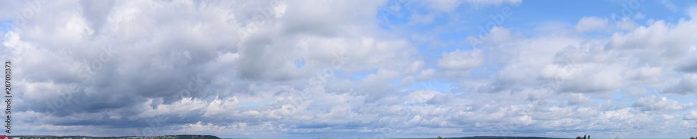 Clouds in the blue sky. The nature of the earth, atmospheric phenomena, its natural manifestations,panorama.