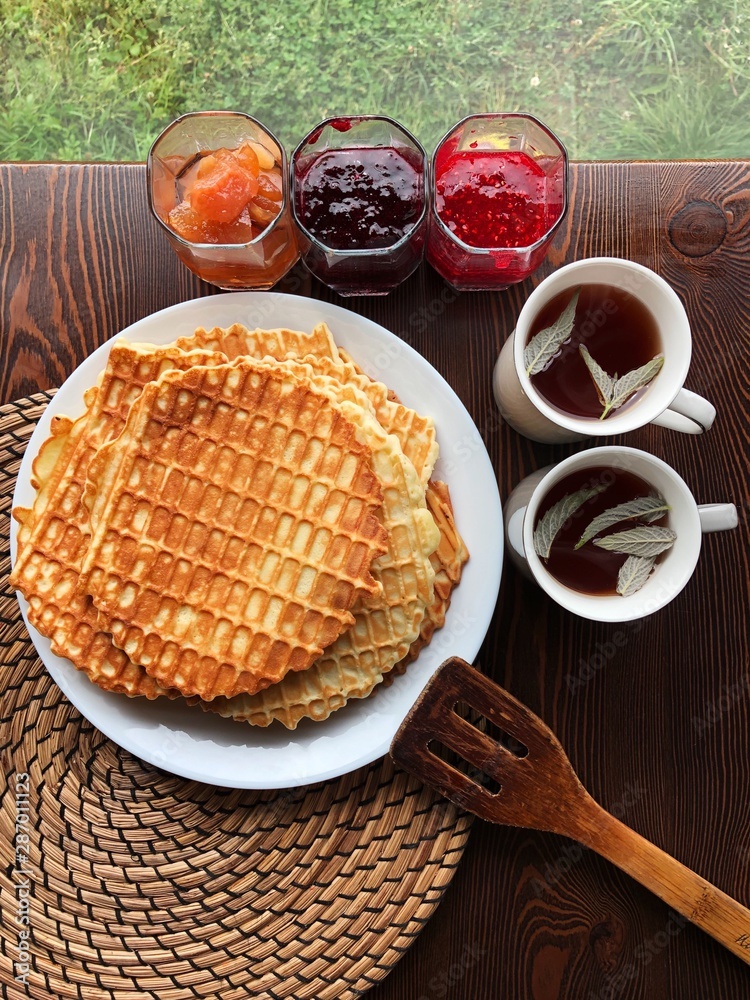 Delicious fresh waffles and jam on the table Delicious fresh waffles and jam on the table