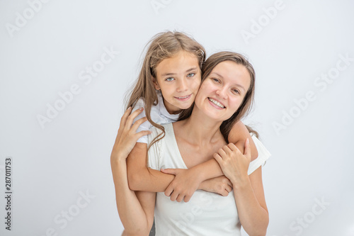 Happy family at home. Mother and daughter have fun at home. Empty space for text
