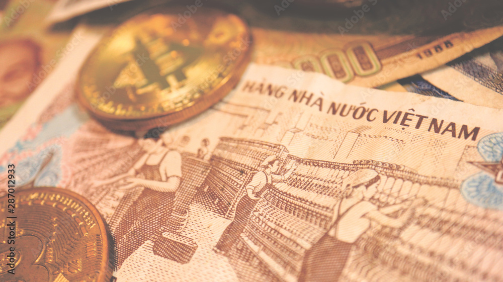 Close up the Vietnamese Dong Banknotes and Bitcoin Close up the Vietnamese Dong Banknotes and Bitcoin