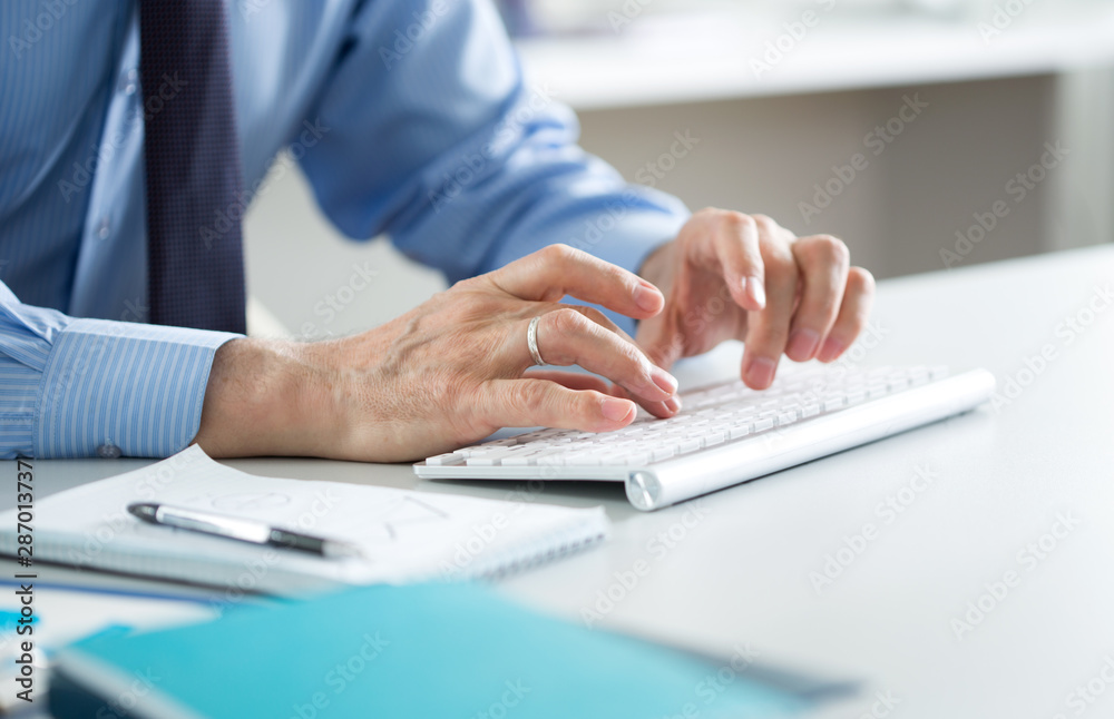 Close-up of hands senior businessman working with computer Close-up of hands senior businessman working with computer