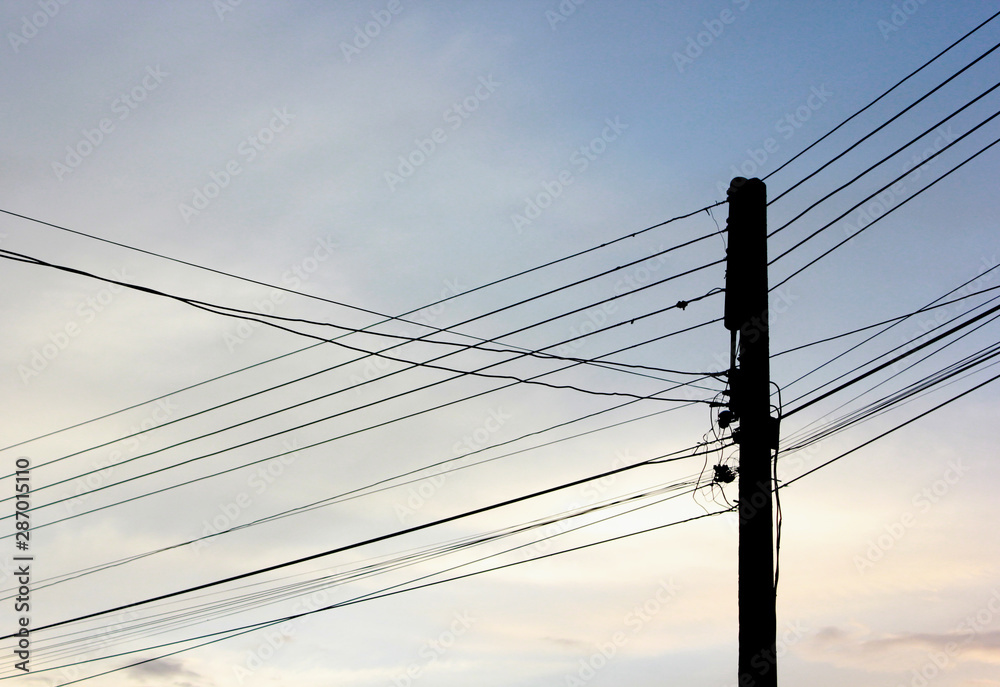 Fototapeta premium Electric poles and electrical wires before sunset in Chiangmai.