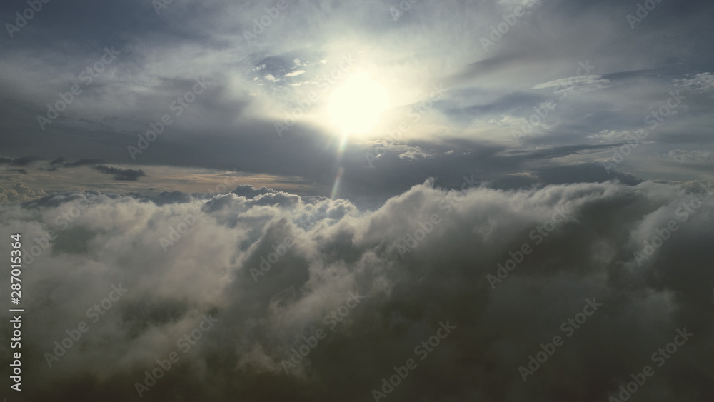 Obraz premium aerial fly above clouds with blue sky in backgroubnd on beautiful sunny day