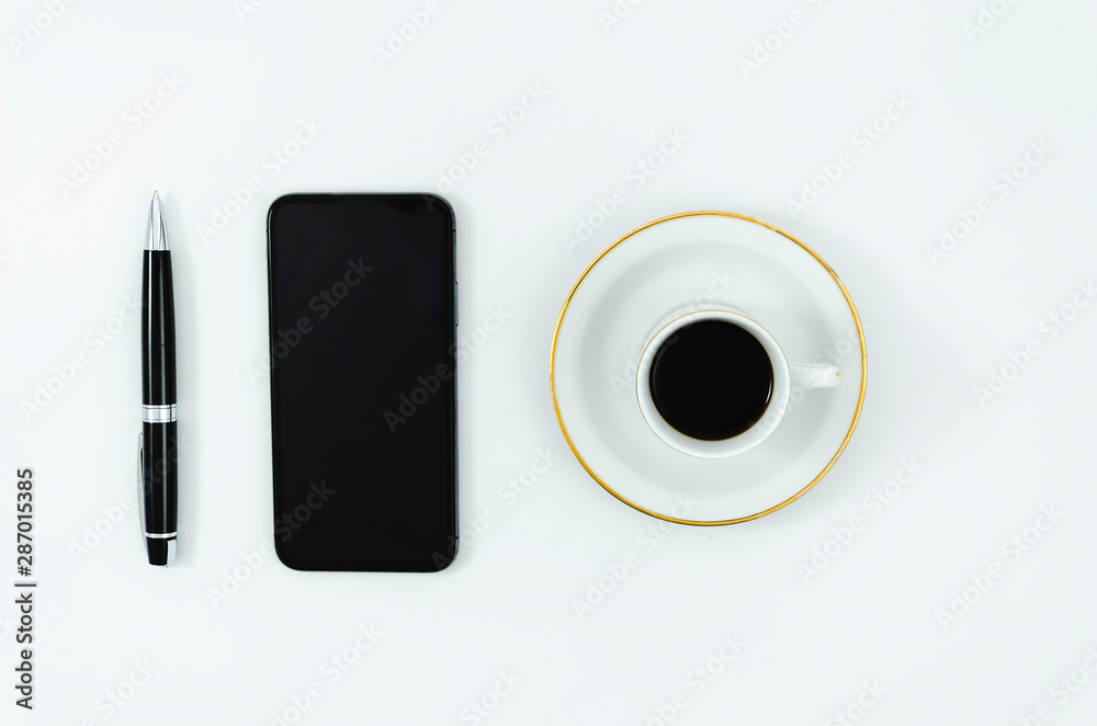 Flat lay business desktop mockup with a smartphone, coffee cup and pen, isolated on white Flat lay business desktop mockup with a smartphone, coffee cup and pen, isolated on white