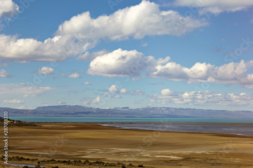 Argentina Patagonia, Calafate region. Beautiul blue sky with white clouds, Plains with a lake and blue mountains in the horizon