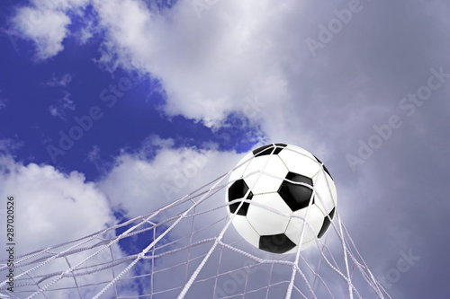 Goal. Soccer ball in net with sky background.