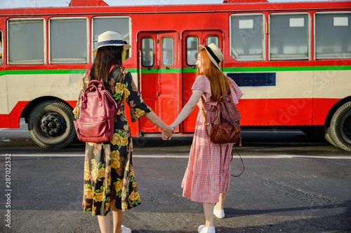 tourist women are going to get in Bus in Bangkok, traveling in urban bus city visit capital of Thailand .