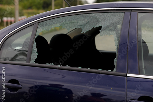Broken car window and cracked glass of a automobile