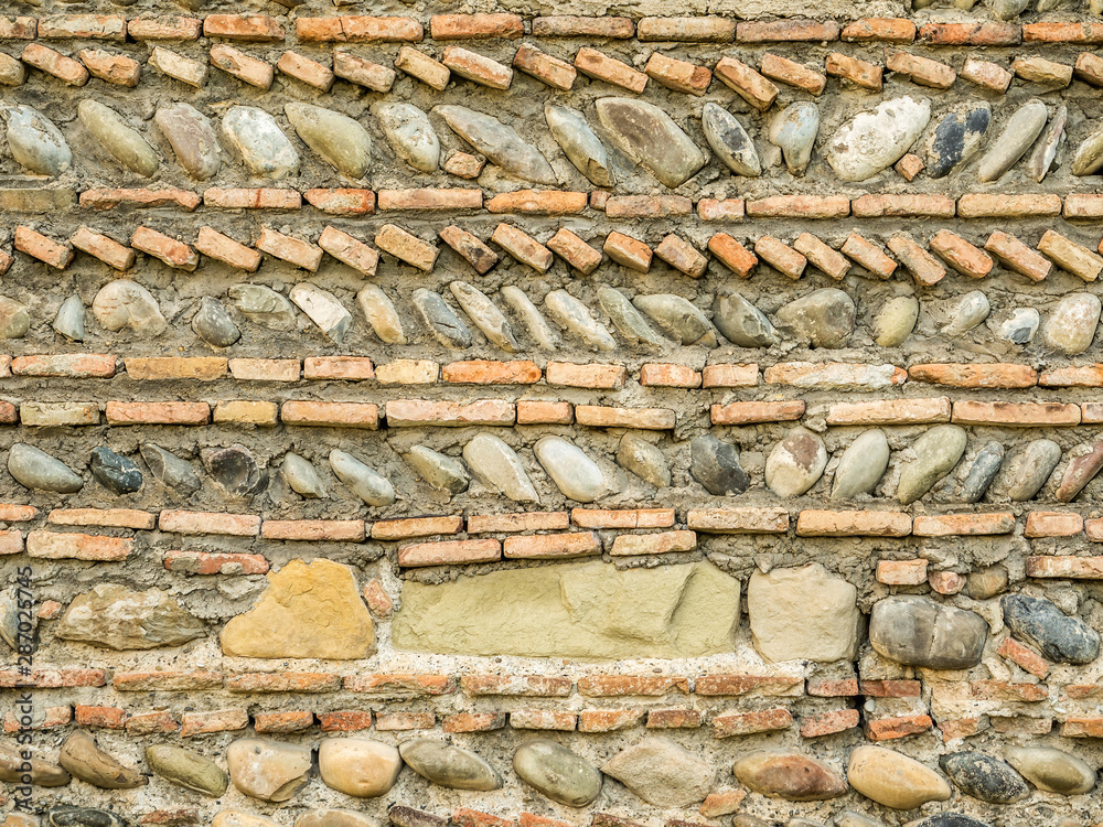 Fortress wall made of brick and stone texture Fortress wall made of brick and stone texture