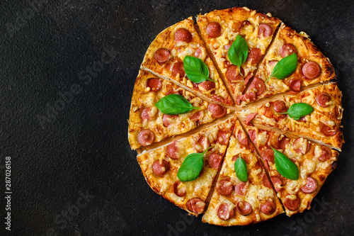 pizza with sausages (tomato sauce, cheese, meat). food background. top view. copy space