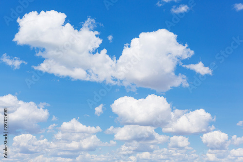 Fototapeta Naklejka Na Ścianę i Meble -  many clouds in the blue sky, in the foreground large cumulus clouds