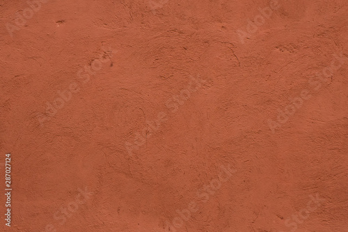 Full frame image of textured stucco in bright terracotta color. High resolution texture of plaster for 3d models, background, pattern, poster, collage, gift wrap, wallpaper etc.