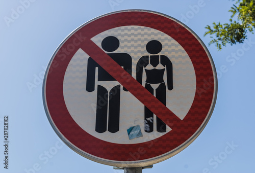 Entry in swimsuit forbidden sign, no swimming suit sign with a blue summer sky background - Image