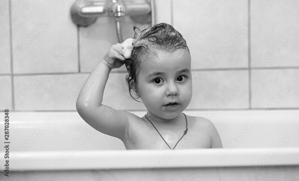 Young children take a bath. Children wash in the bathroom. Brother and sister play in the bathroom during water procedures.