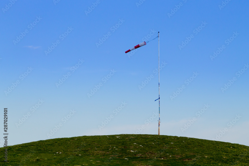 Isolated windsock on blue sky, sport background