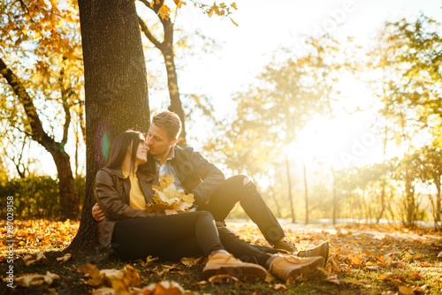 Lovely beautiful couple enjoying each other. Beautiful autumn day. Lifestyle, happy couple of two play on a sunny day in the park. The concept of youth, love and lifestyle.