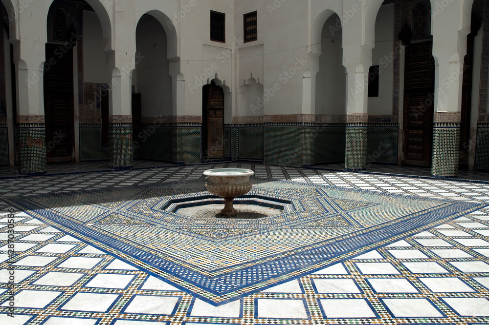 Obraz premium Marrakesh Morocco, interior courtyard with fountain and zellige tiled floor at Dar Si Said