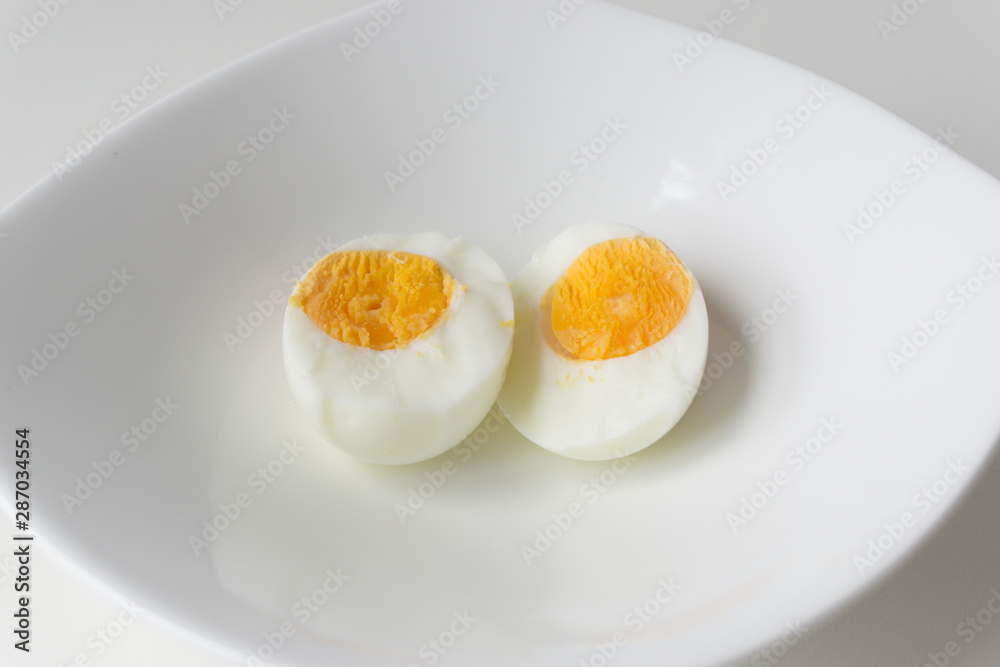 Sliced boiled eggs on white plate, Ready to eat. Sliced boiled eggs on white plate, Ready to eat.