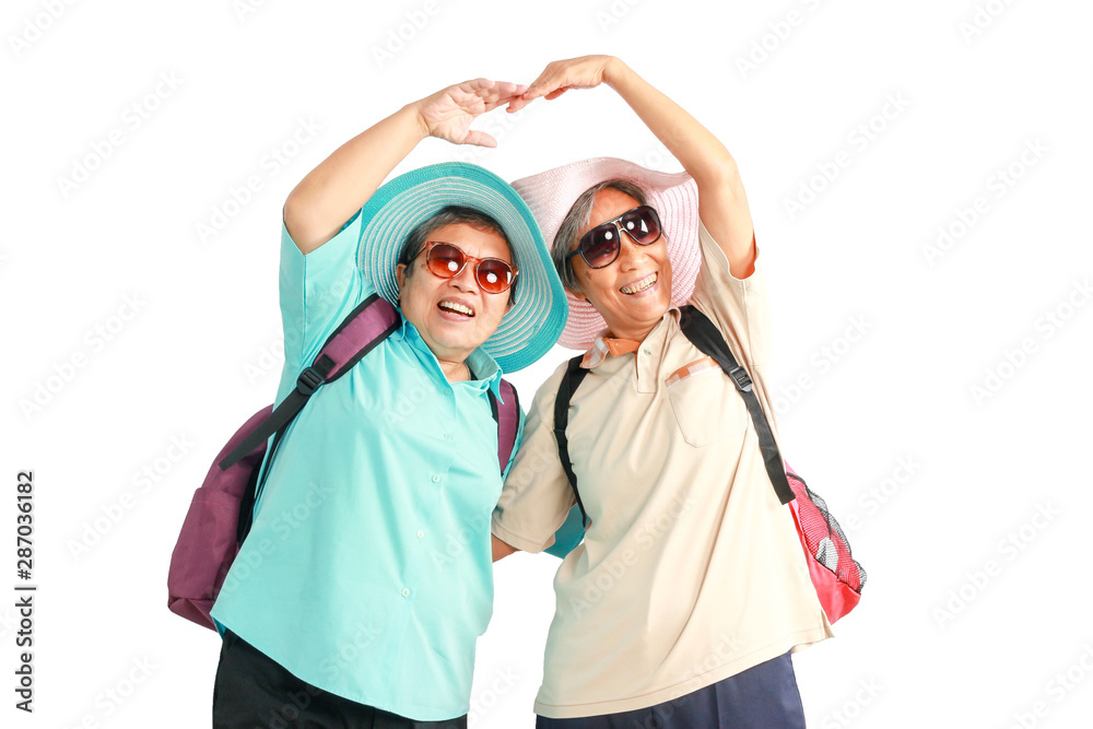 Happy elderly buddy traveling together, senior Asian women tourist with backpack wear hat and sunglasses isolated on white background. Mature female travelers feel excited and joyful with journey trip