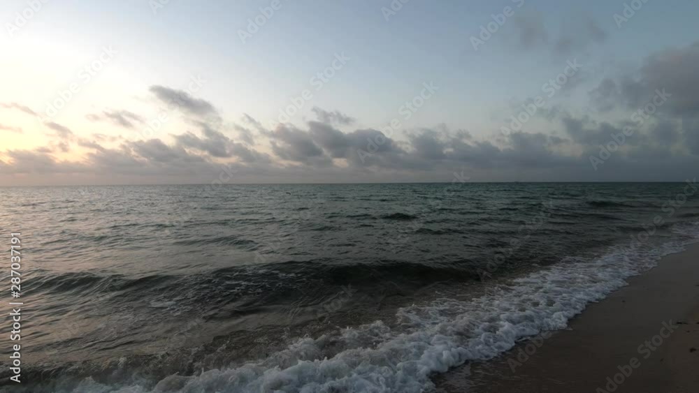 4K Slow motion view tidal waves hitting fine sand shore at sunrise, Miami Beach 4K Slow motion view tidal waves hitting fine sand shore at sunrise, Miami Beach