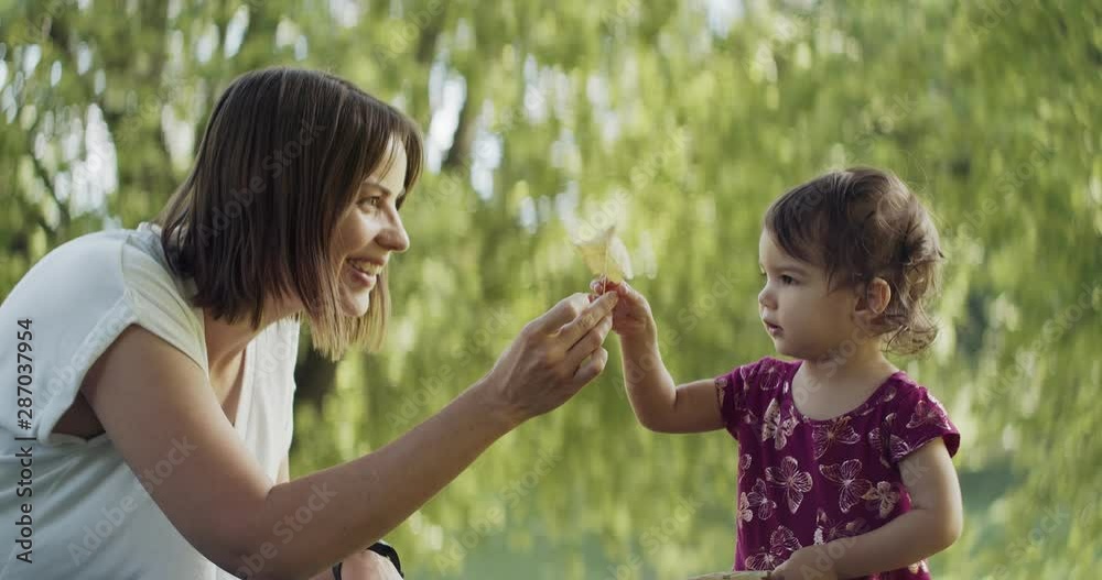 Mother and her baby daughter exploring the outdoors. 4K real life, candid footage. Mother and her baby daughter exploring the outdoors. 4K real life, candid footage.