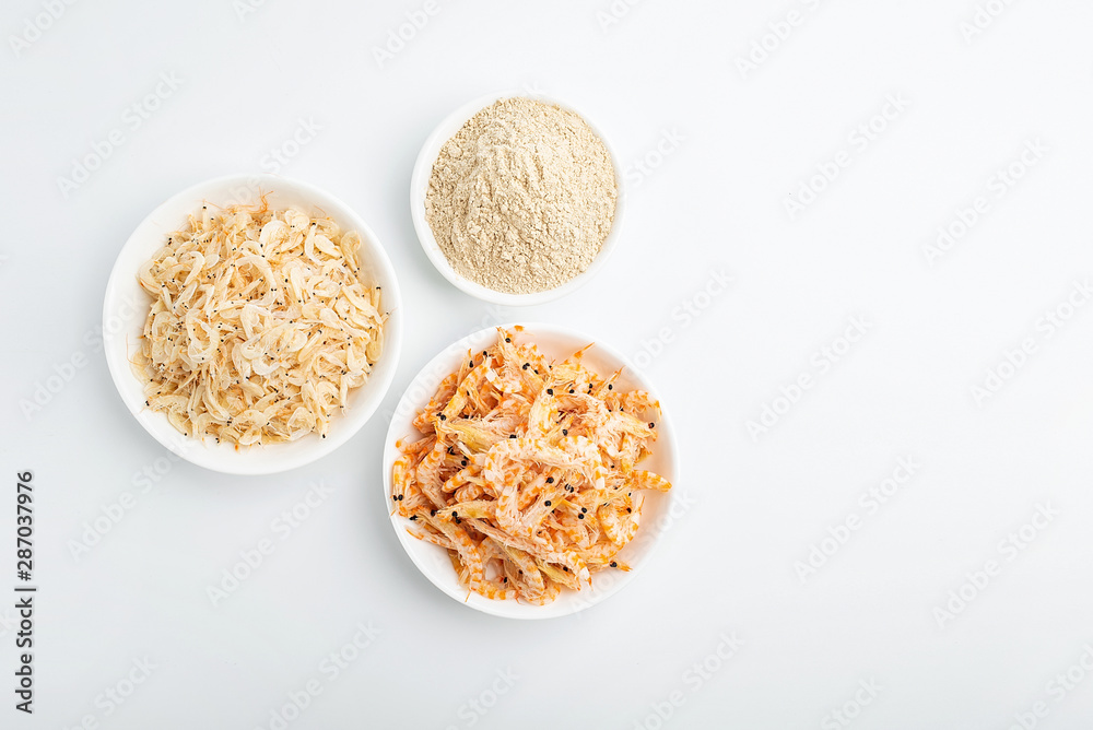 Dried seafood white shrimp and shrimp skin powder on white background Dried seafood white shrimp and shrimp skin powder on white background